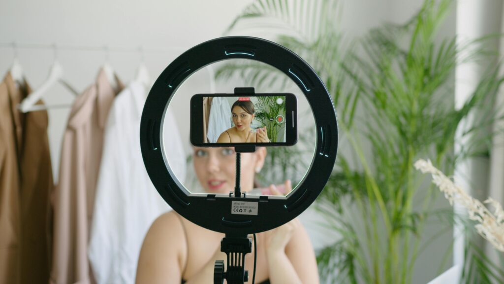 Woman filming video with a ring light.